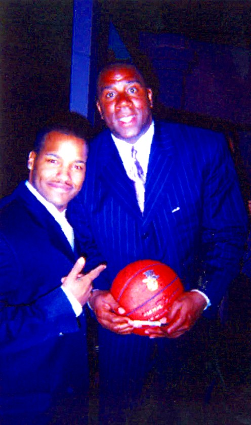 Dai with Magic Johnson as he autographs the memorial basketball given to Dai